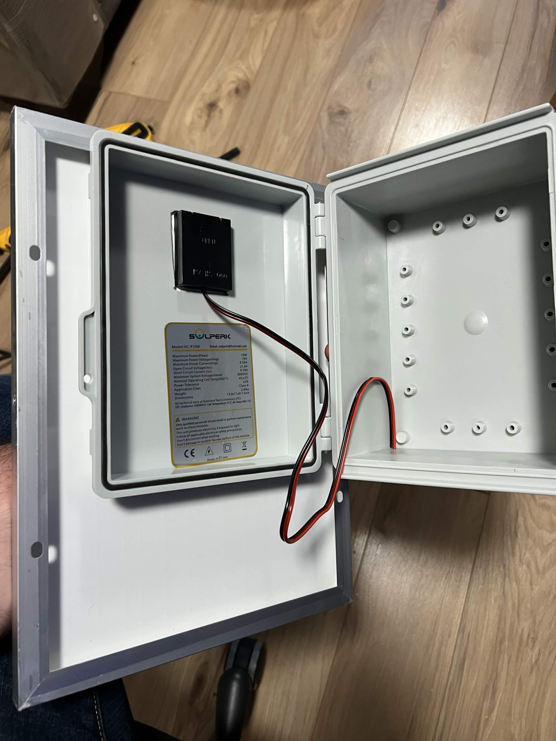 Solar-panel wires routed through the enclosure cutout