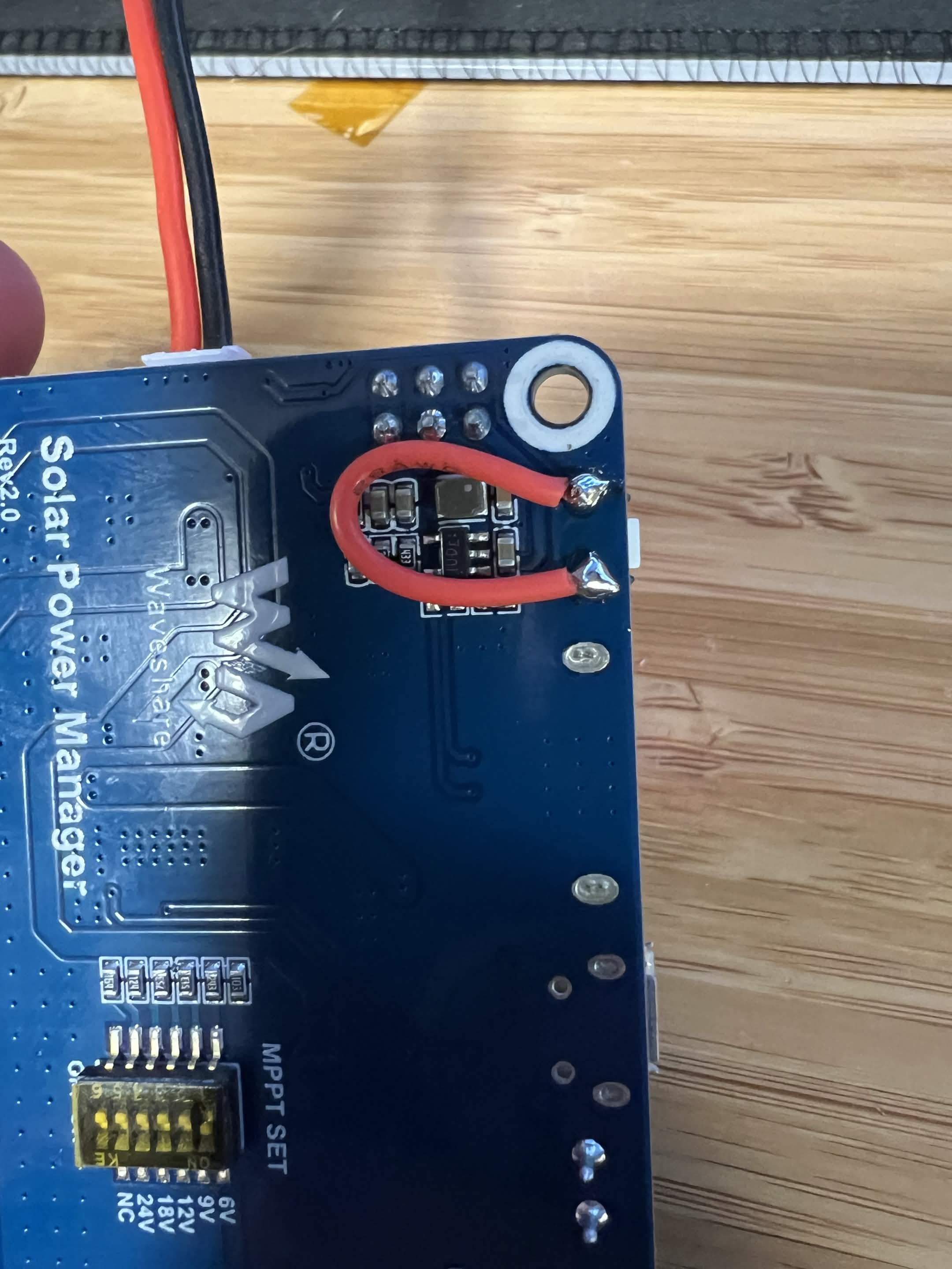 Unverified wire bridge across solar-manager boot-button pads